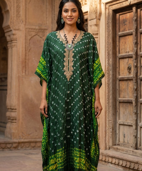 Women wearing emerald green Bandhani print georgette kaftan maxi dress with zari embroidery neckline and yellow tie-dye border