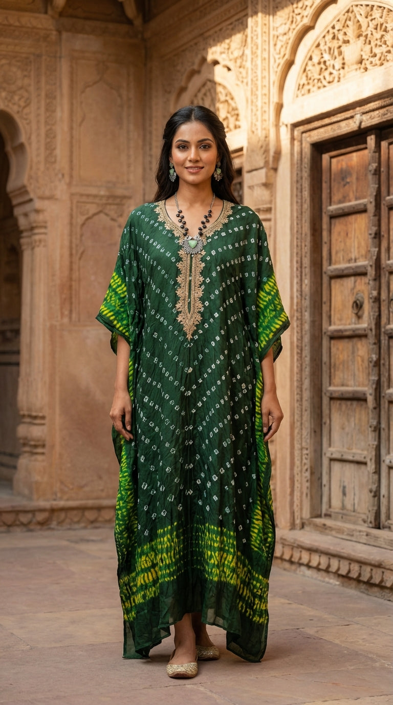Women wearing emerald green Bandhani print georgette kaftan maxi dress with zari embroidery neckline and yellow tie-dye border
